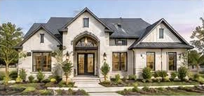 White brick custom home with a grand arched entry