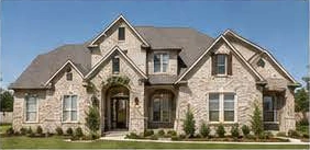 Traditional stone custom home with multiple gables